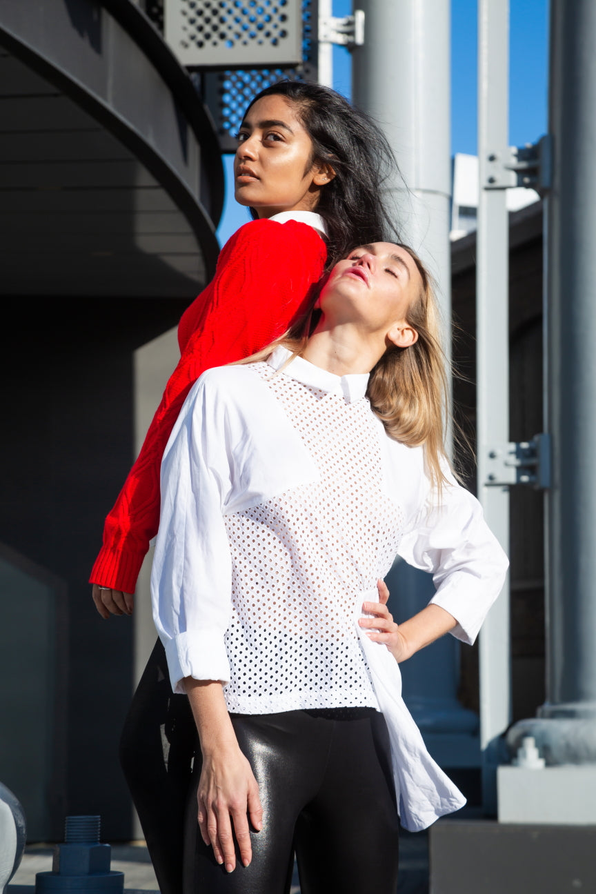 Two women standing close together with one wearing a red jacket and the other in a white blouse. White dotted blouse — handmade white designer blouse with delicate dot print from Major Minor Jakarta, relaxed fit, limited edition
