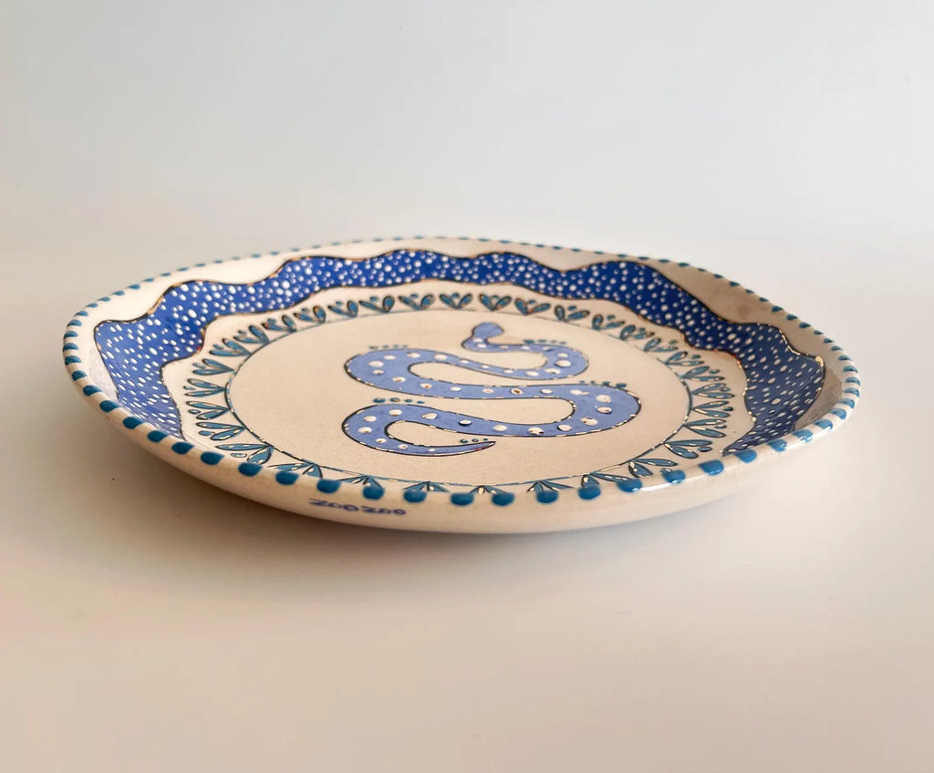 Ceramic plate with blue decorative elements on a plain background