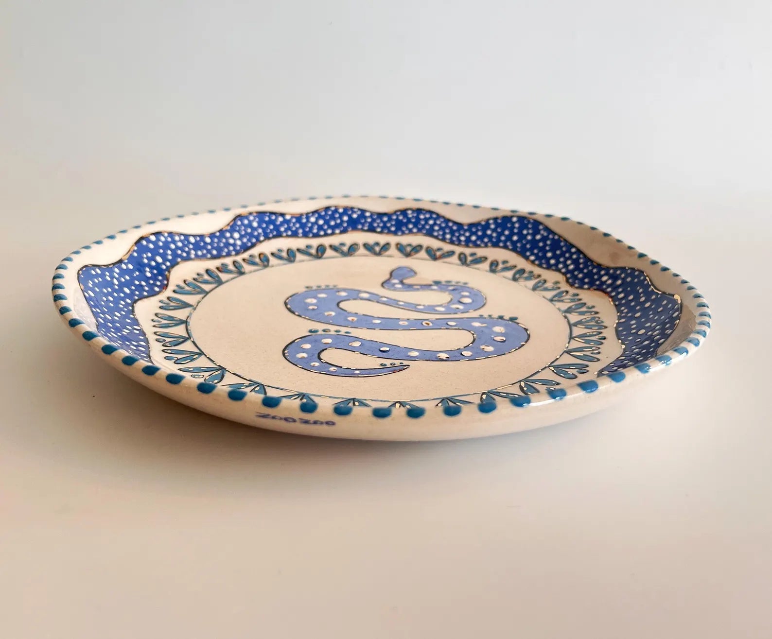 Ceramic plate with blue decorative elements on a plain background