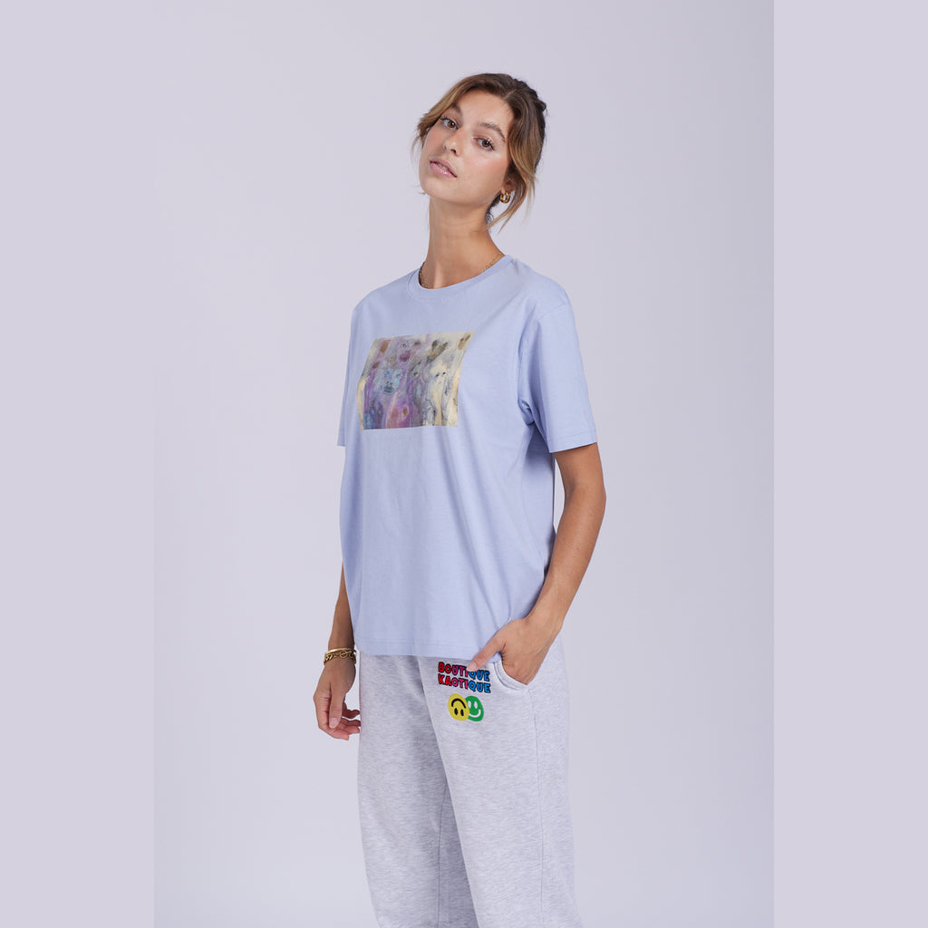 A serene blue organic cotton t-shirt with a hidden ghost abstract design on the front. Hidden Ghosts tee — serene blue organic cotton t-shirt with ghost print, unisex fit, mental health charity tee
