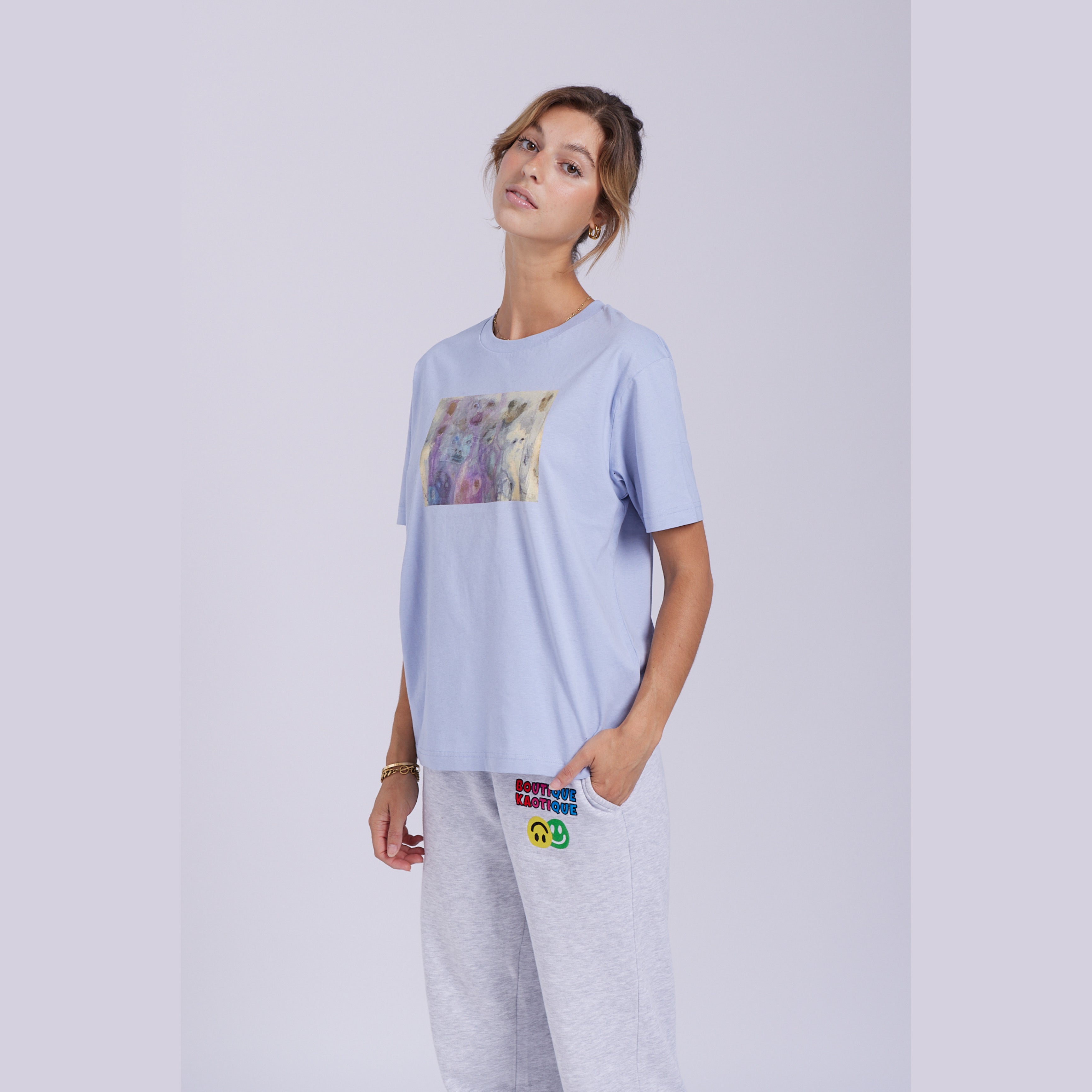 A serene blue organic cotton t-shirt with a hidden ghost abstract design on the front. Hidden Ghosts tee — serene blue organic cotton t-shirt with ghost print, unisex fit, mental health charity tee