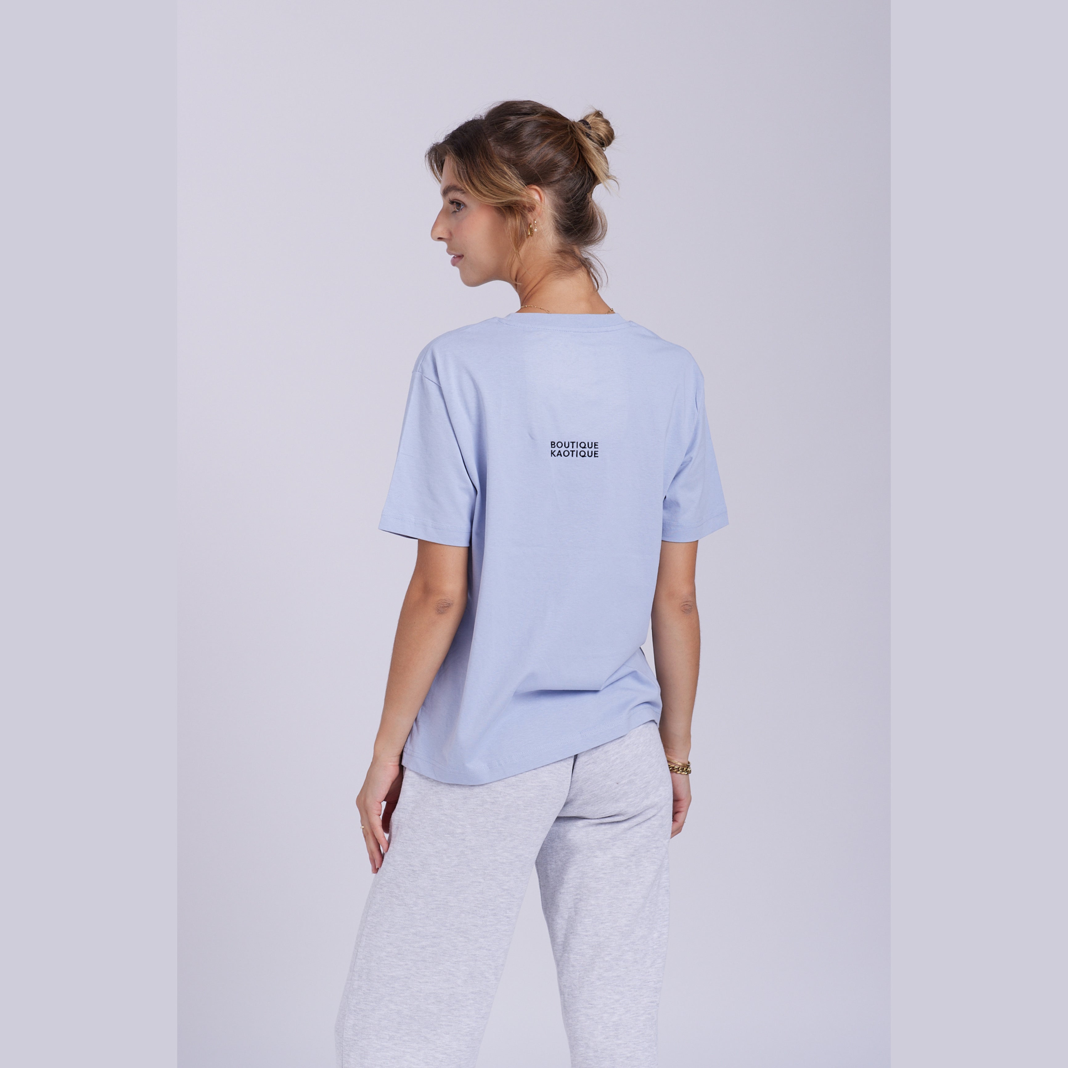 A serene blue organic cotton t-shirt with a hidden ghost abstract design on the front. Hidden Ghosts tee — serene blue organic cotton t-shirt with ghost print, unisex fit, mental health charity tee