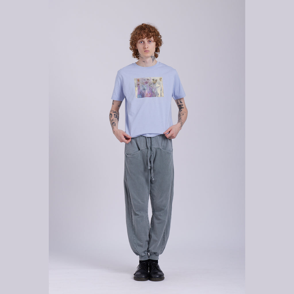A serene blue organic cotton t-shirt with a hidden ghost abstract design on the front. Hidden Ghosts tee — serene blue organic cotton t-shirt with ghost print, unisex fit, mental health charity tee