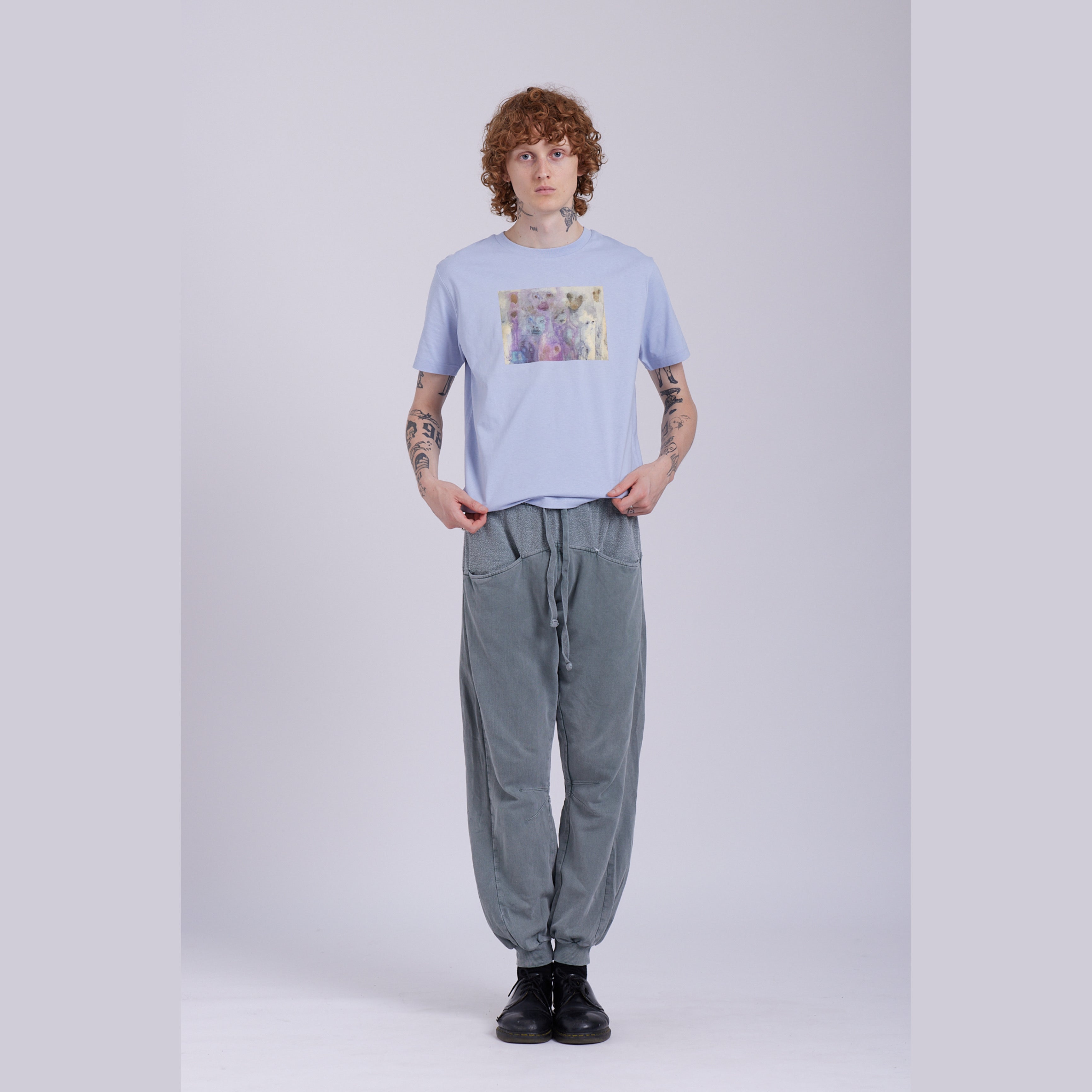 A serene blue organic cotton t-shirt with a hidden ghost abstract design on the front. Hidden Ghosts tee — serene blue organic cotton t-shirt with ghost print, unisex fit, mental health charity tee