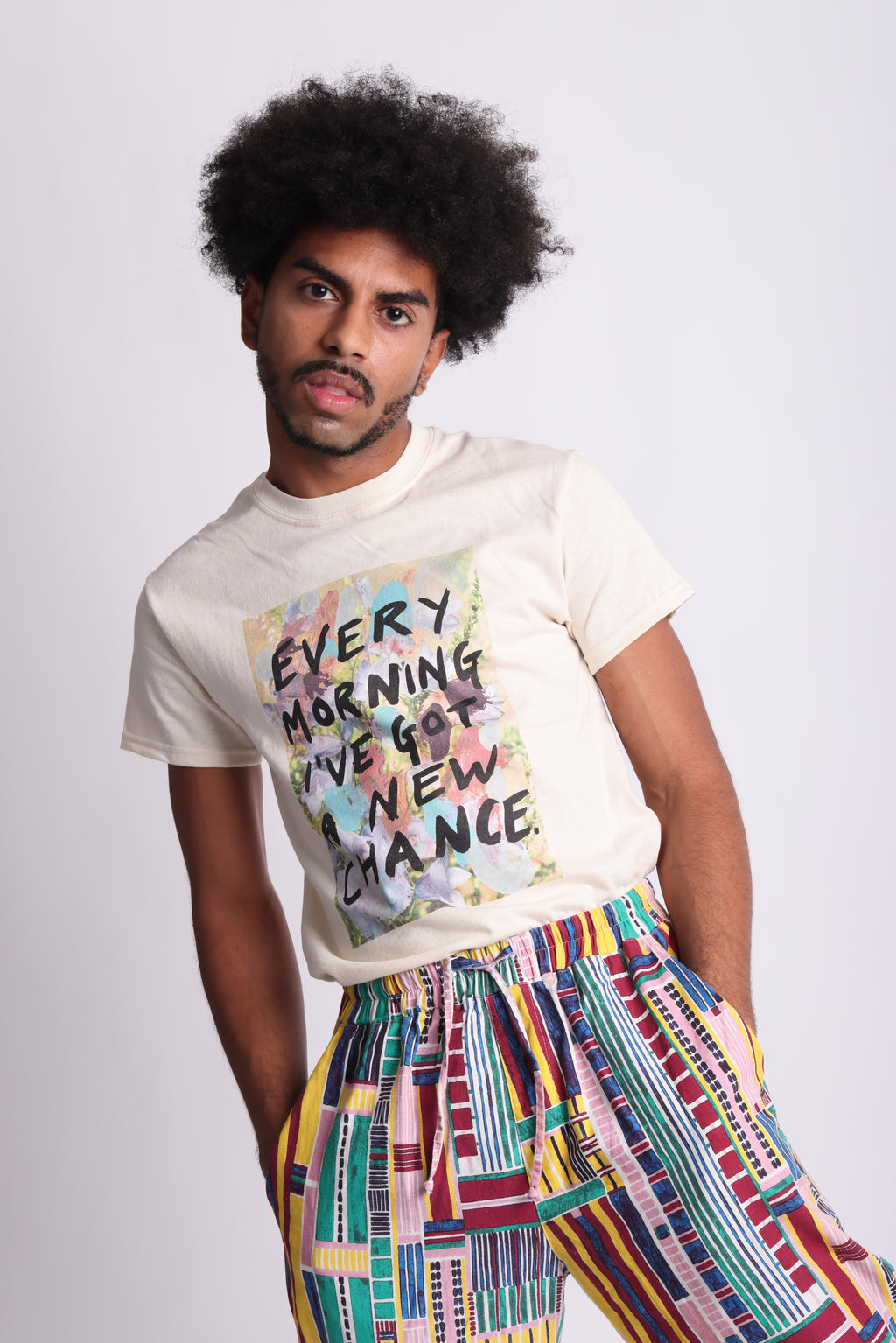A organic cotton t-shirt with a printed front featuring the text 'EVERY MORNING I'VE GOT A NEW CHANCE' surrounded by a multicolored abstract design. Every Morning affirmation tee — white organic cotton t-shirt with mental health print, unisex fit, charity tee by emerging artist