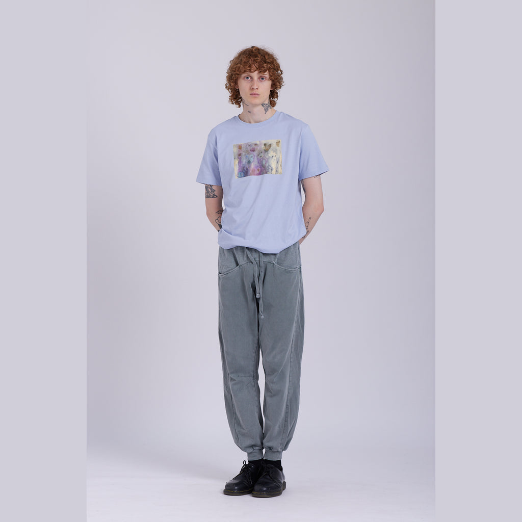 A serene blue organic cotton t-shirt with a hidden ghost abstract design on the front. Hidden Ghosts tee — serene blue organic cotton t-shirt with ghost print, unisex fit, mental health charity tee