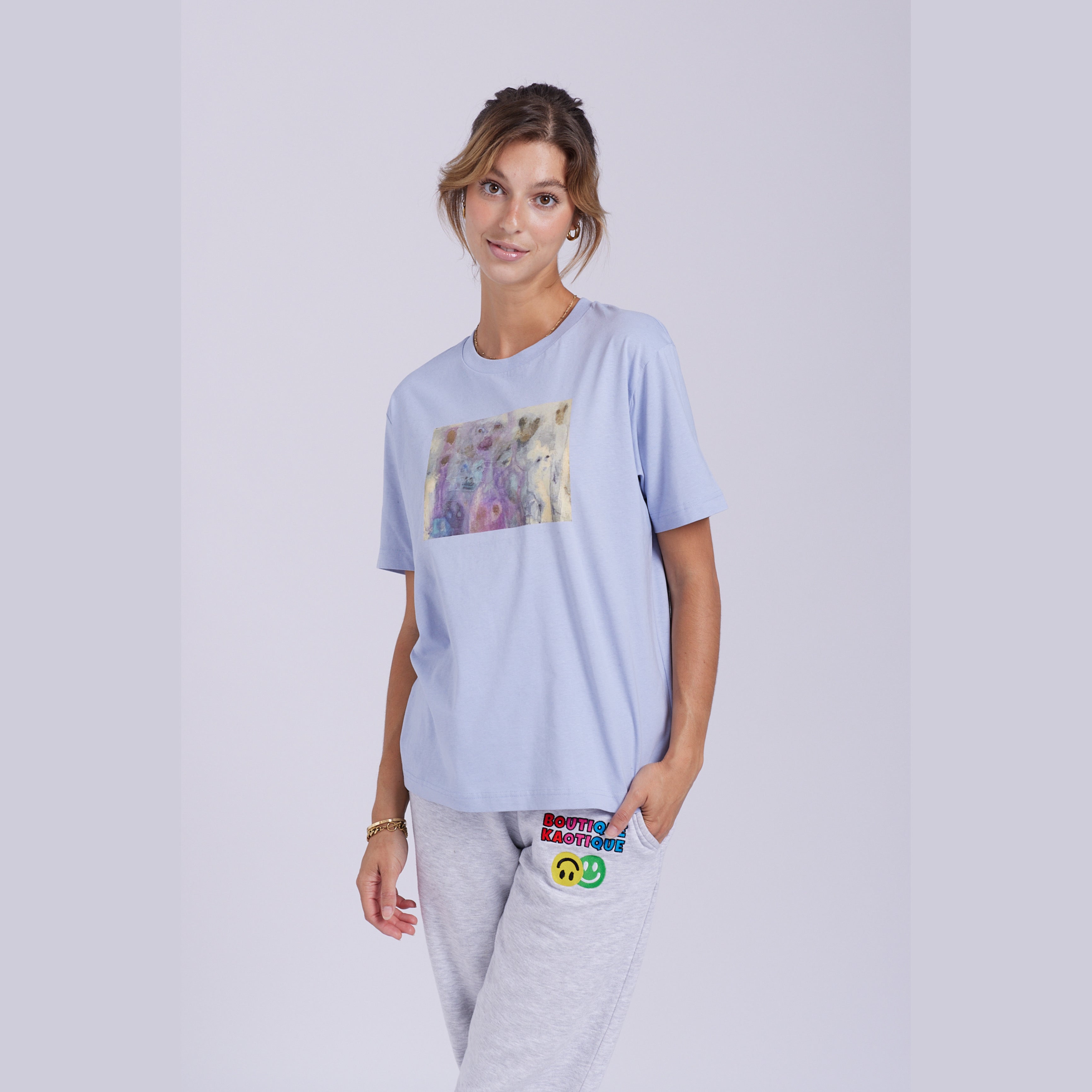 A serene blue organic cotton t-shirt with a hidden ghost abstract design on the front. Hidden Ghosts tee — serene blue organic cotton t-shirt with ghost print, unisex fit, mental health charity tee